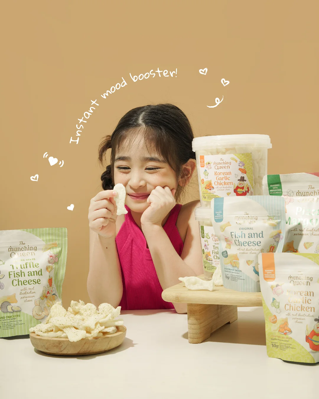 A smiling child enjoying The Munching Queen Fish and Cheese snacks
